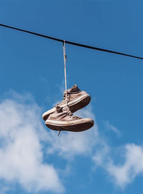 sneakers hanging from wires.